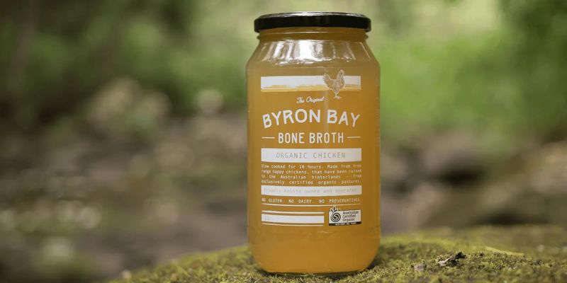 A jar of Byron Bay Bone Broth on a mossy rock in the hinterland