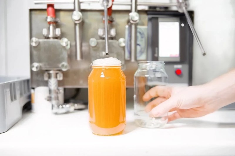 Broth being filled into jars in the Byron Bay kitchen