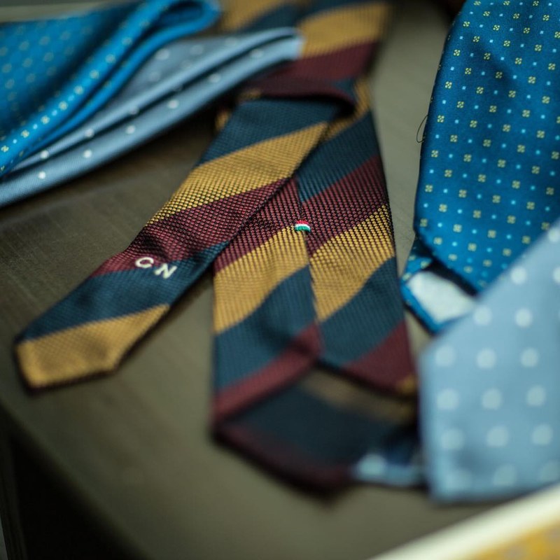 A striped grenadine tie with CN embroidered on the blade