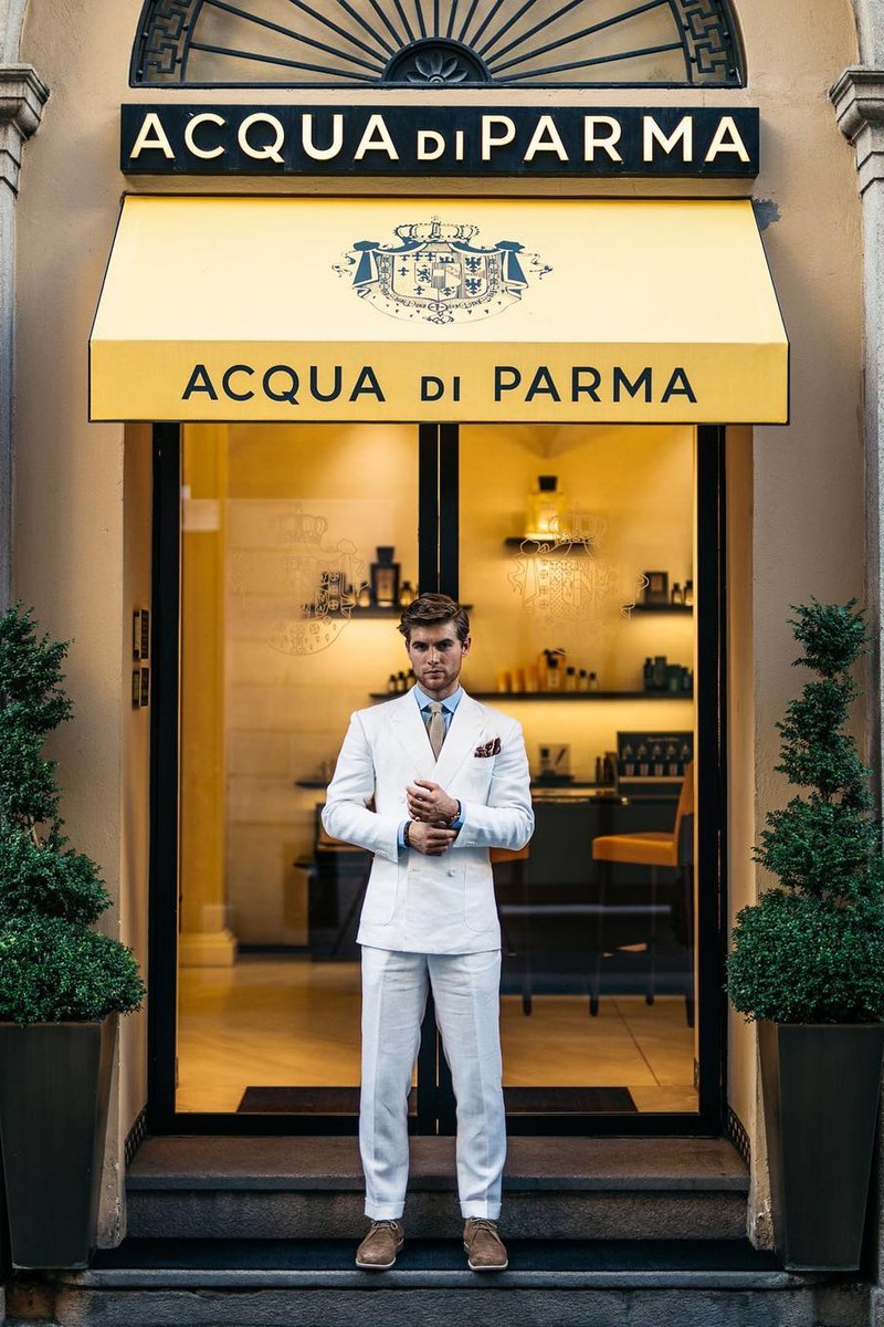 A white double-breasted linen suit outside the Acqua di Parma boutique in Milan