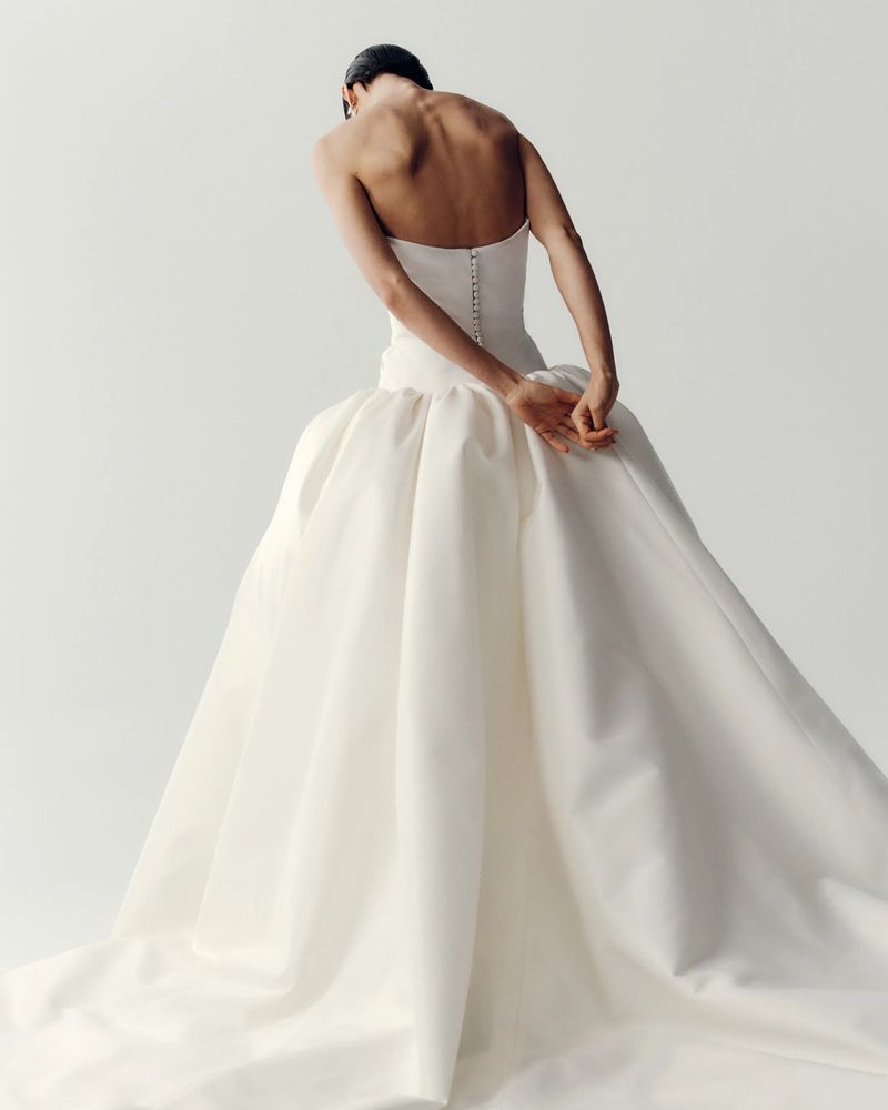 Back view of a strapless Elly Sofoclí corset gown with a full skirt