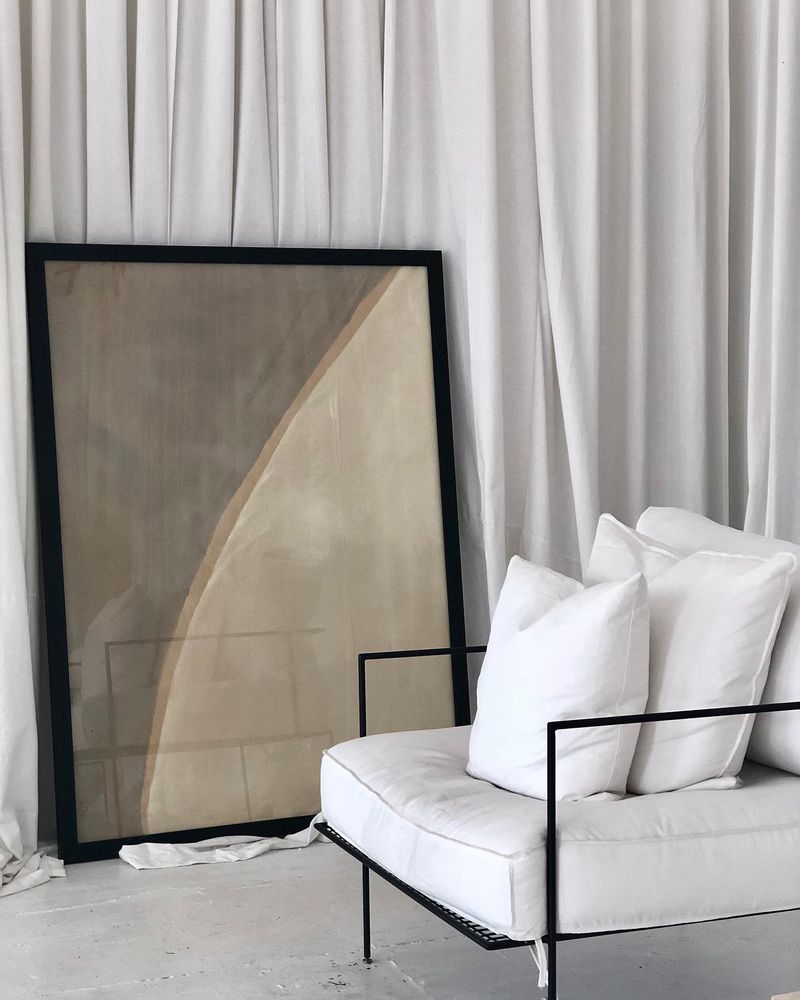 The Elly Sofoclí studio, with a framed artwork and a white sofa
