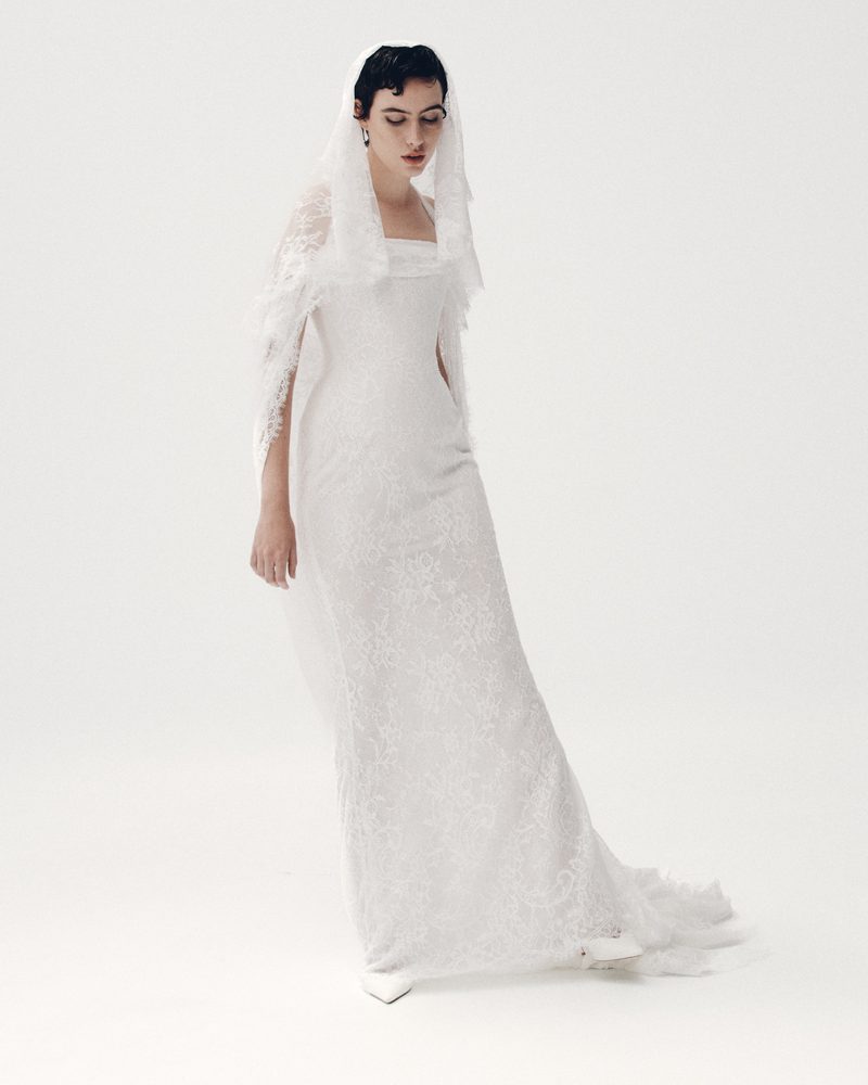 Model in a fitted lace Elly Sofoclí column gown and veil