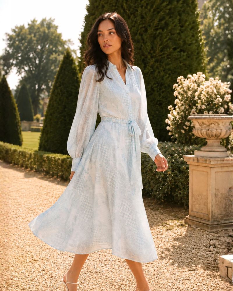 Spring Collection campaign: a model in a pale blue dress in a formal garden