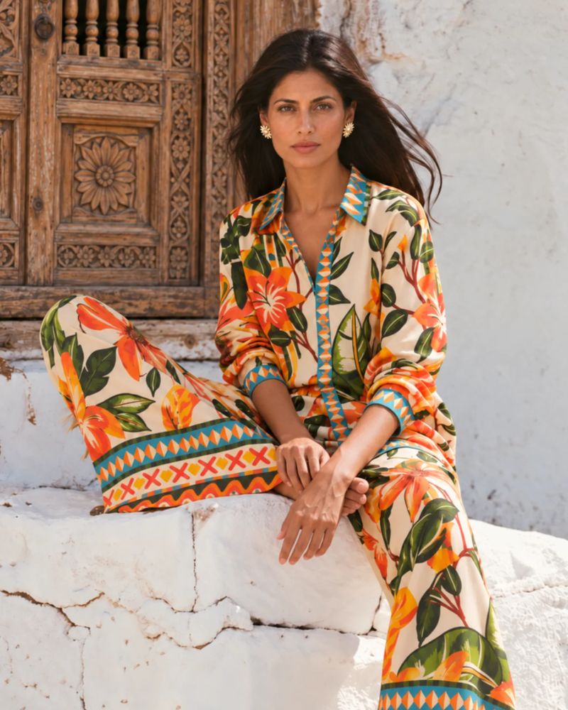 Vacation Vibes campaign: a model in a tropical print shirt and trousers