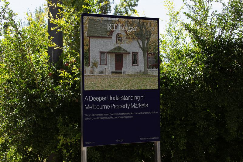 RT Edgar sales board in a garden setting