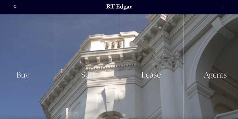 The RT Edgar website home page on desktop over a heritage facade